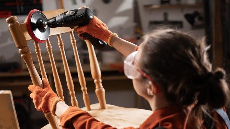 A woman sanding with a drill accessory