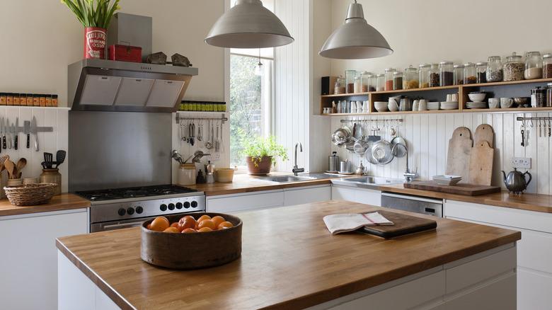 kitchen with white and wood tones, more rustic feel with open shelving and butcher block counter tops