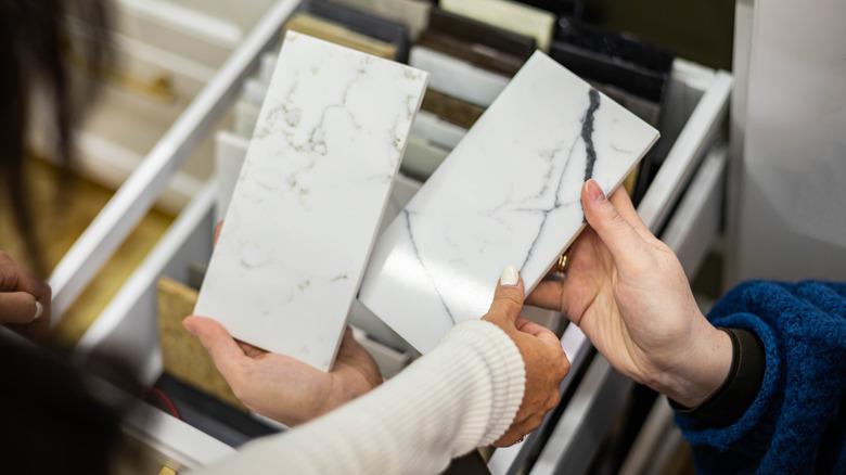people deciding between two different countertop samples.