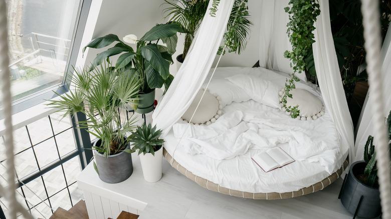 Hanging rounded bed in airy loft