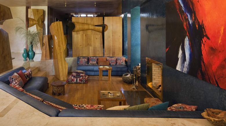 1970s style home with a sunken living room surrounded by blue couches