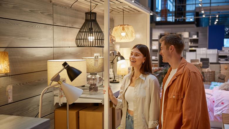 man and woman shopping for lighting at a store