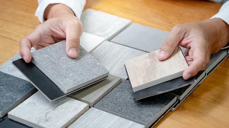 person choosing tiles from samples