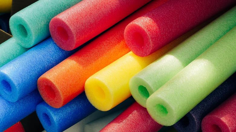 colorful pool noodles stacked in pile