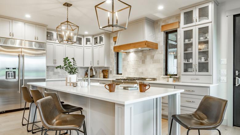 a modern kitchen with white cabinets and wood accents