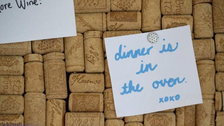 Notes pinned to a wine cork board