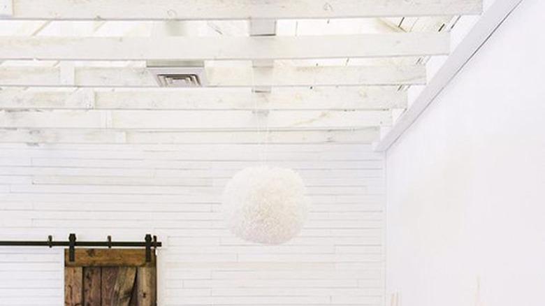 Bohemian bedroom with white-painted ceiling beams
