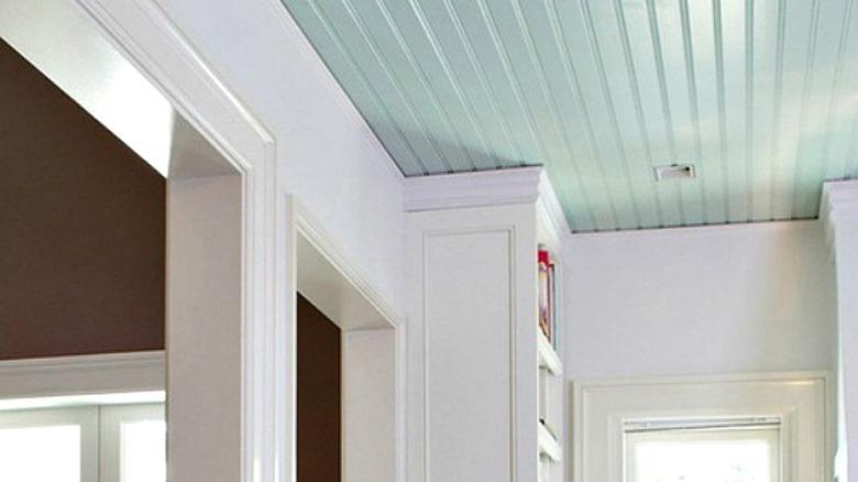 Black and white kitchen with pale turquoise ceiling