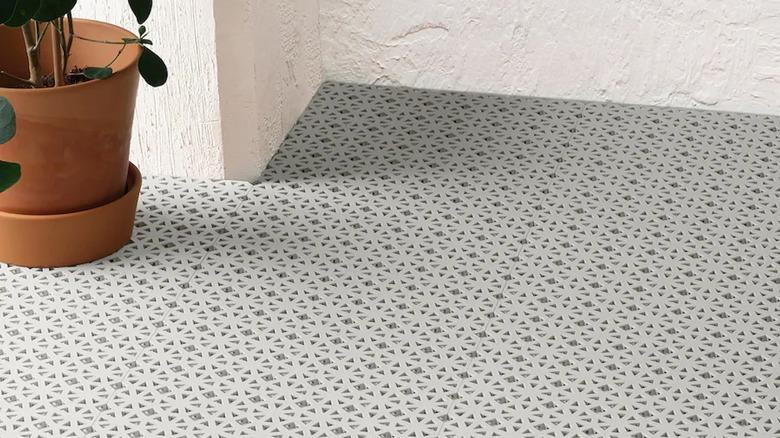 IKEA ALTAPPEN decking floor tiles installed on a patio with a plant on top