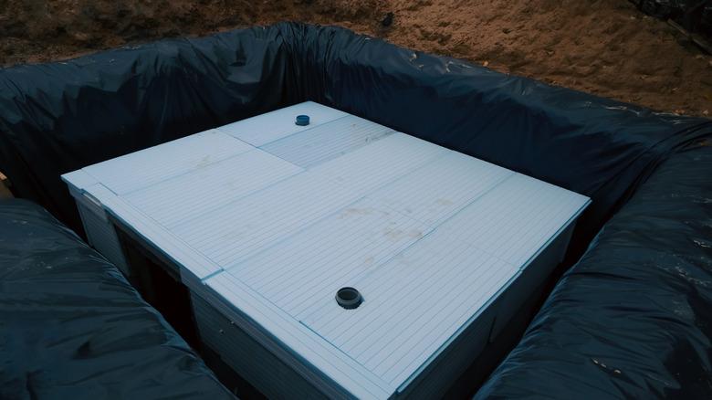 underground bunker being built in a hole surrounded by dirt