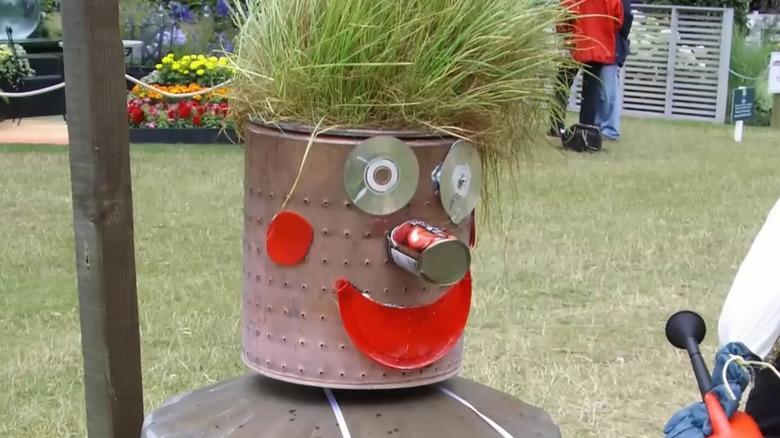 Scarecrow made from reused cans and CDs