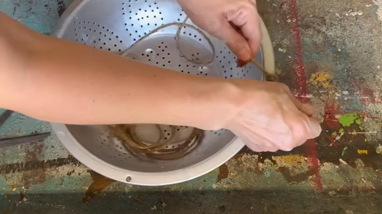 Making a hanging basket from an old colander
