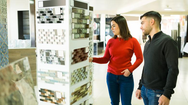 A woman and man shopping for backsplash options