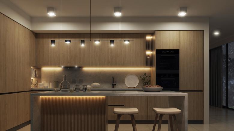 Modern lighting in kitchen with oak cabinets