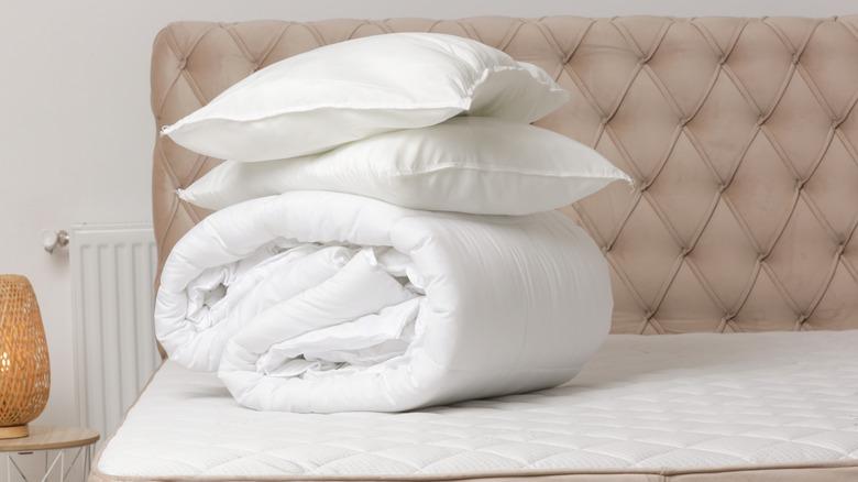 folded white bedding and pillows