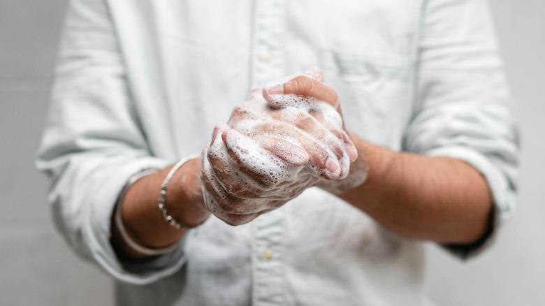 Person wiping soapy hands