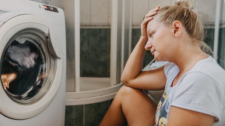 miserable woman broken washing machine