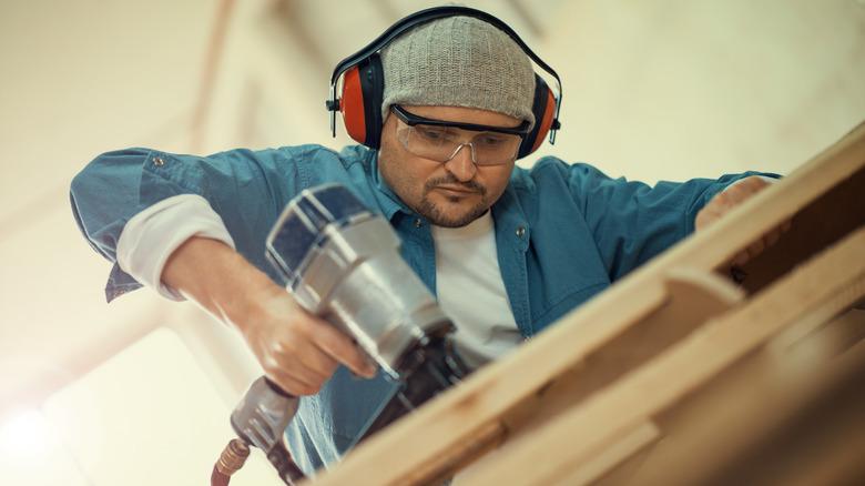 person working with nail gun