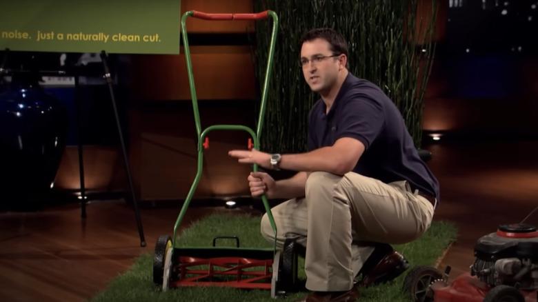 Humphrey demonstrating the Ecomower's cutting blade system on Shark Tank
