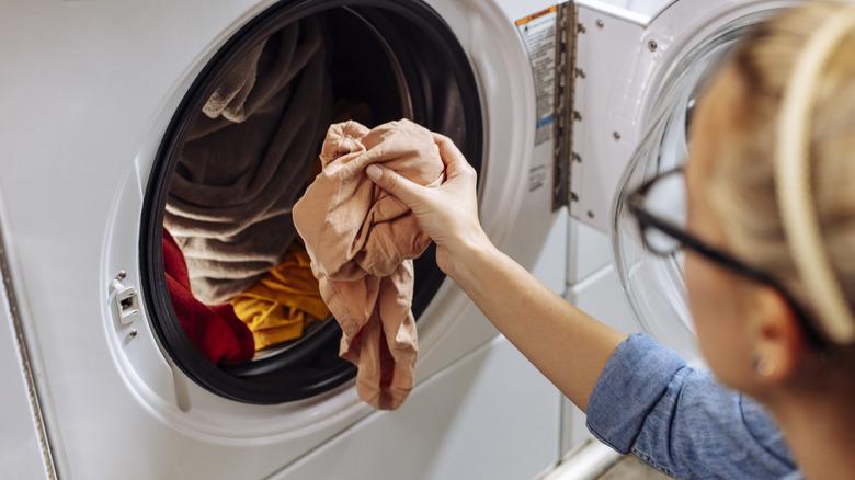 woman filling up washing machine