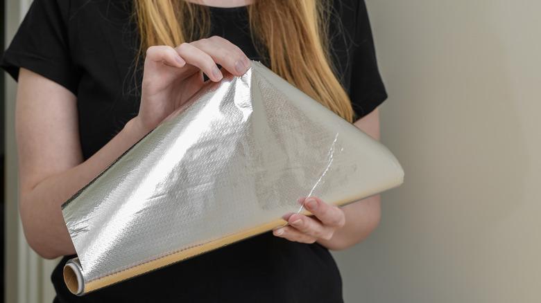Woman holding aluminum foil