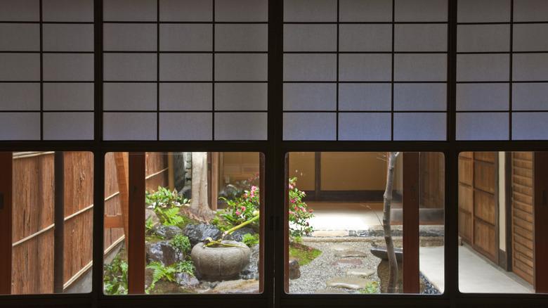A Japanese courtyard garden as seen through windows