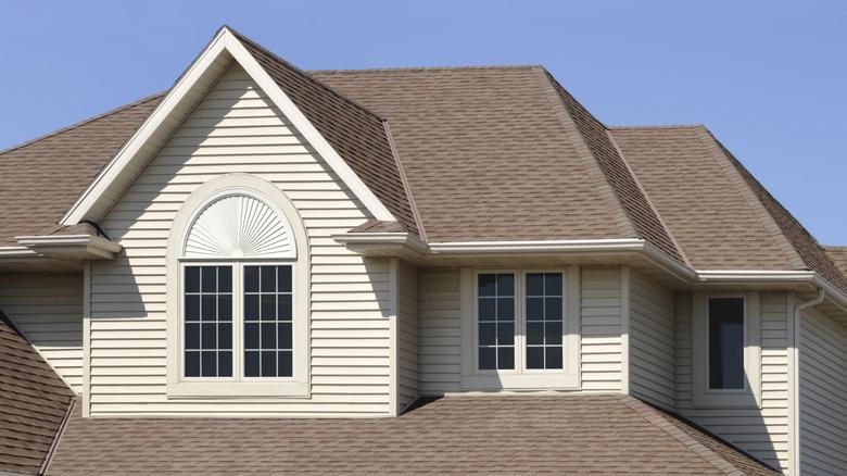 house with beige siding and tan shingled roof