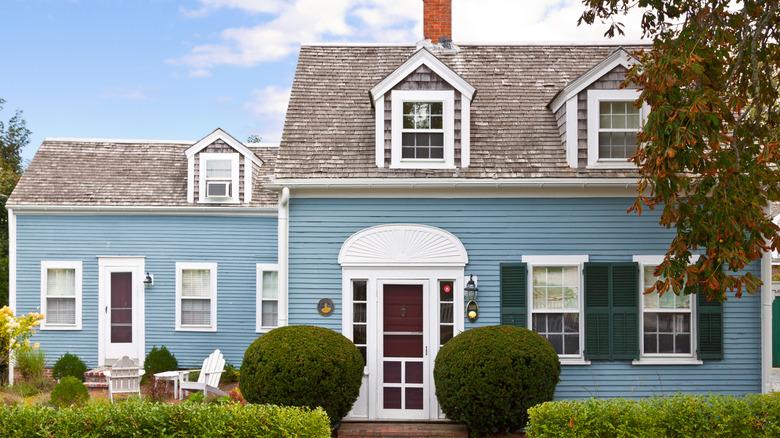 house with light blue siding, white trim, and tan shingle roof