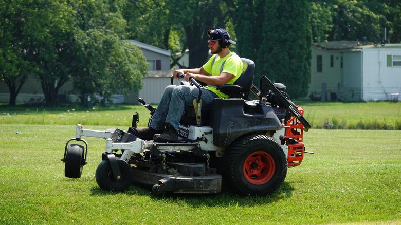 Man on zero-turn lawn mower